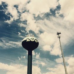 Low angle view of street light against cloudy sky