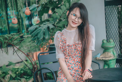 Full length of young woman standing outdoors