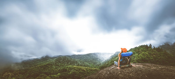 Rear view of man standing on mountain