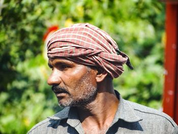 Close-up of man wearing turban looking away