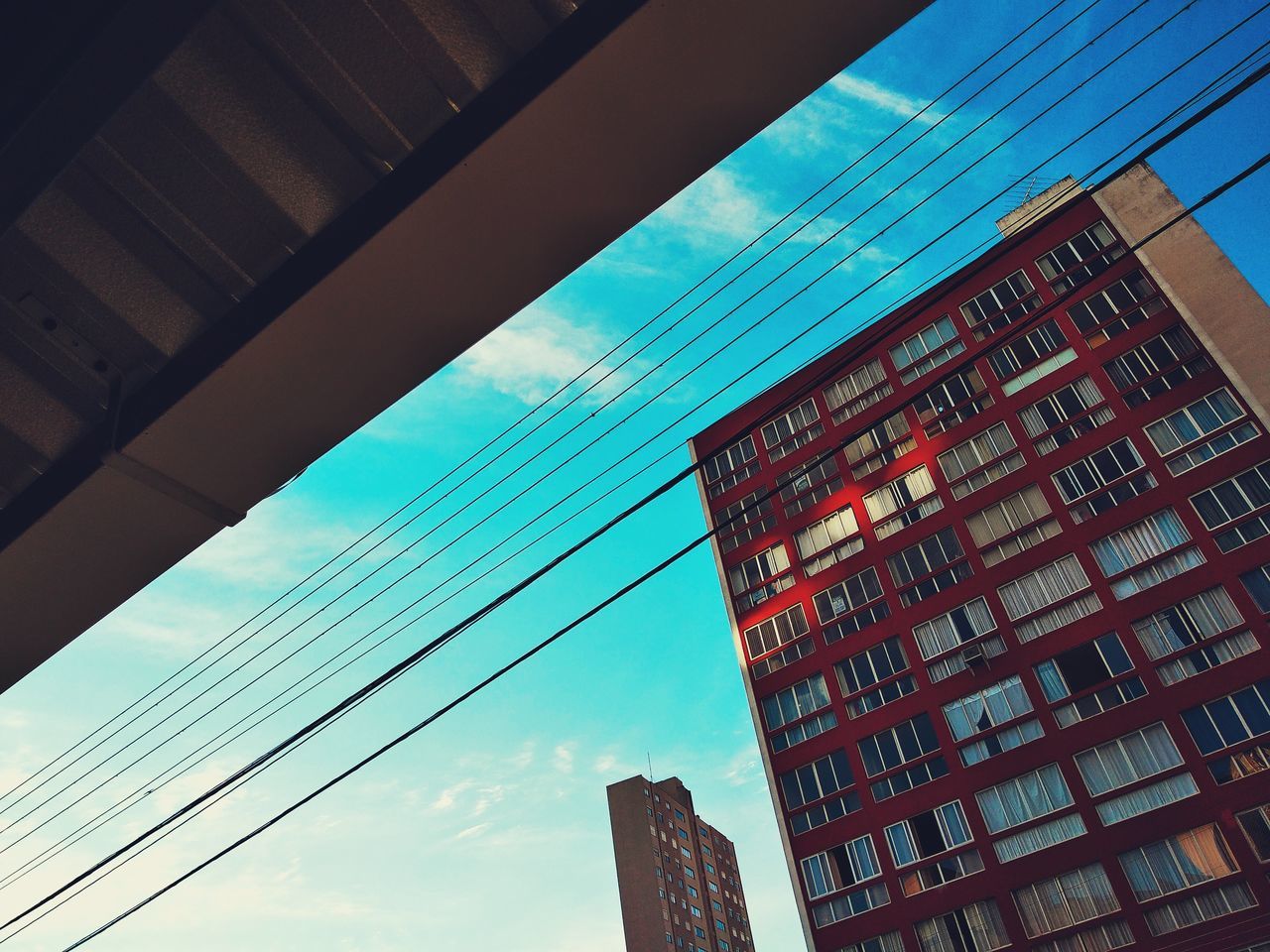 architecture, building exterior, built structure, building, sky, low angle view, city, cloud - sky, no people, day, nature, office, office building exterior, window, tall - high, outdoors, residential district, glass - material, cable, modern, skyscraper, apartment