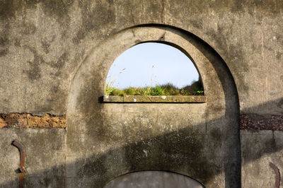 Close-up of arch window against wall