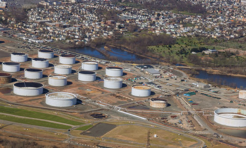 High angle view of factory by buildings in city