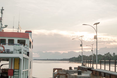 Pier by sea against sky during sunset