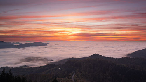 Sunset over the mist-covered entrance to the murg valley in the german black forest