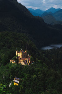 High angle view of castle, mountains and lake