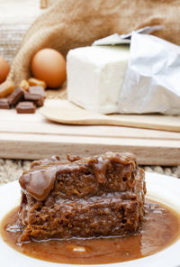 Sticky toffee pudding serving with selective focus and ingredients in background