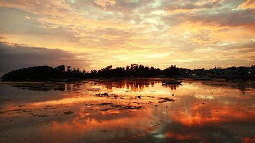 Scenic view of lake against orange sky