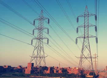 Low angle view of electricity pylon against sky