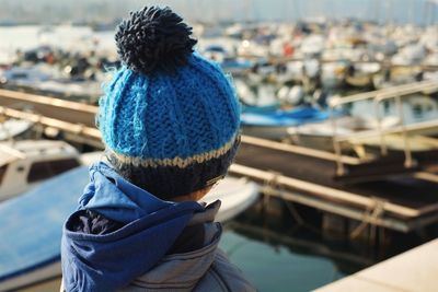 Rear view of woman wearing knit hat at harbor