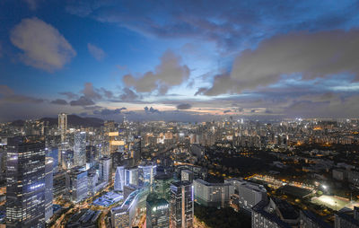 High angle view of illuminated city buildings against sky