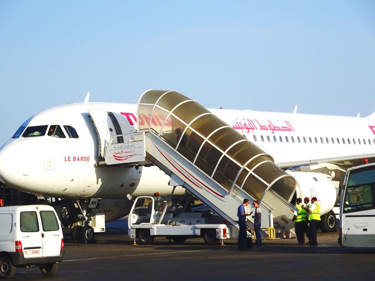 AIRPLANE ON AIRPORT RUNWAY AGAINST SKY