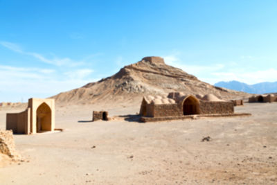 Built structure on arid landscape against sky