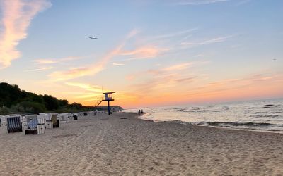 Scenic view of beach against sky during sunset