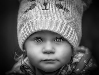 Close-up portrait of cute baby girl wearing knit hat