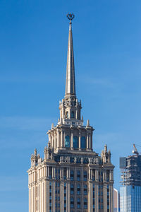 Low angle view of buildings against blue sky