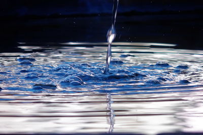 Close-up of water splashing in glass