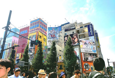 People on street in city against sky