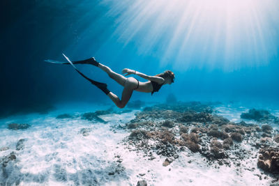 Low angle view of woman swimming in sea