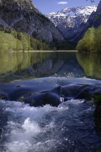 Scenic view of lake by snowcapped mountains