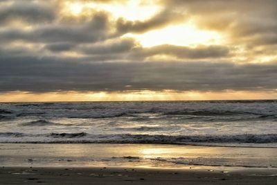 Scenic view of sea against cloudy sky