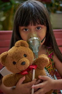 Portrait of a boy drinking from toy