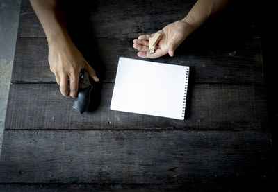 High angle view of woman reading book on table