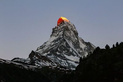Low angle view of snowcapped mountain against sky