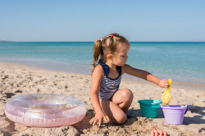 Girl playing with toy on beach