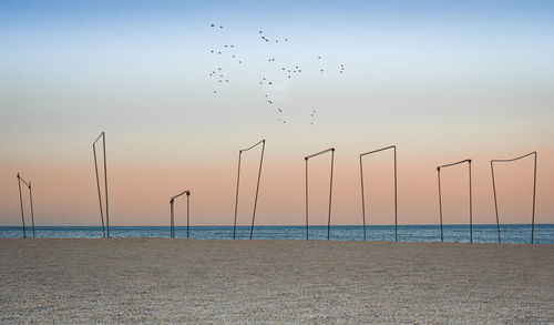 Scenic view of beach against sky during sunset