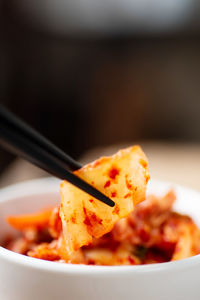 Close-up of chopsticks with food at table