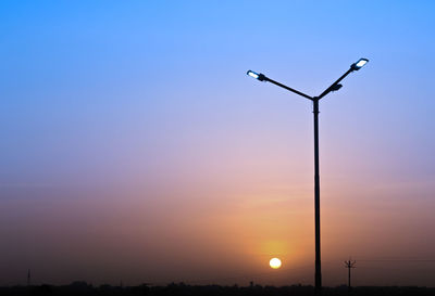 Low angle view of street light against sky during sunset