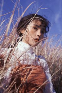 Portrait of woman looking away on field