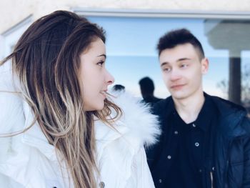 Couple looking at each other while standing outdoors