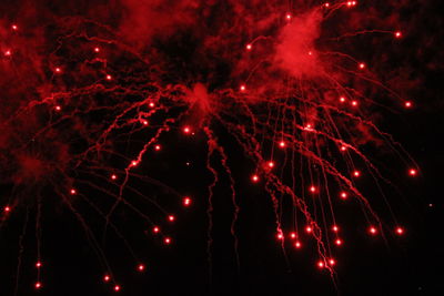 Low angle view of firework display at night