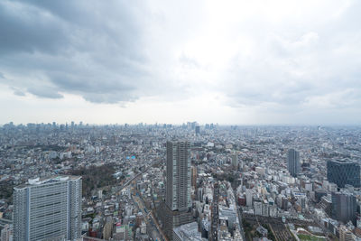 High angle view of modern buildings in city against sky