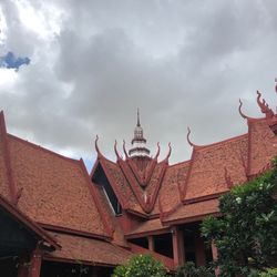 Low angle view of roof of building against cloudy sky