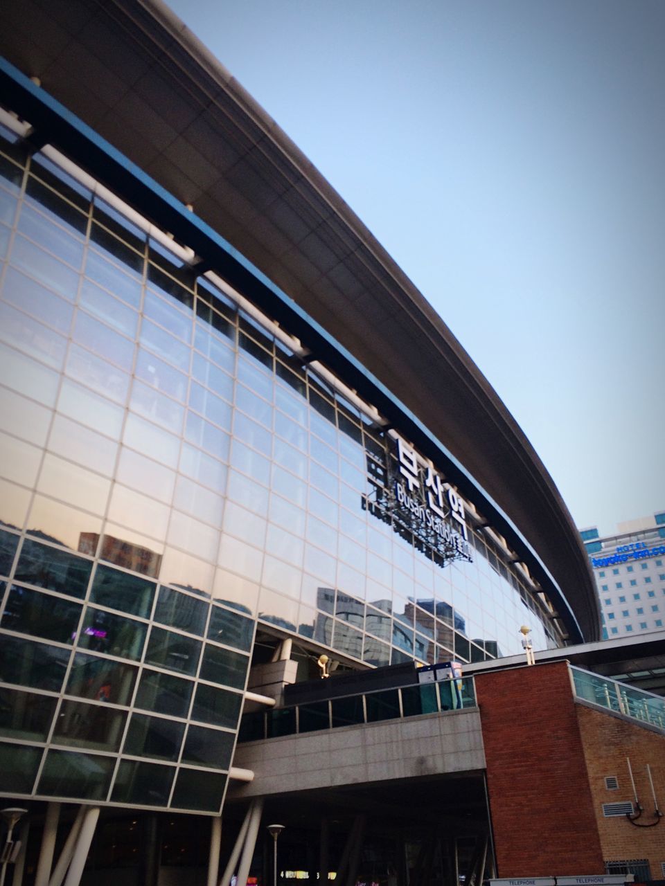 architecture, built structure, building exterior, low angle view, modern, city, glass - material, office building, building, sky, window, clear sky, reflection, skyscraper, day, city life, no people, outdoors, tall - high, architectural feature