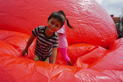 Cute boy and girl jumping on inflatable