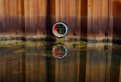 Digital composite image of wooden post with reflection