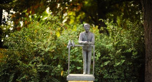 Low angle view of statue against trees