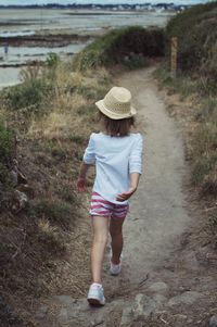 Rear view of woman walking on street