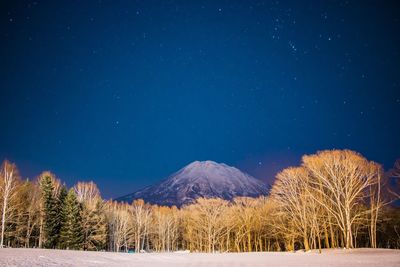 Scenic view of mountains against sky at night