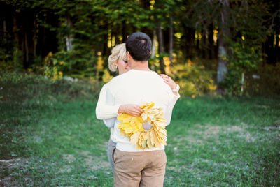 Rear view of young woman standing on field