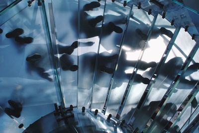 High angle view of people walking in glass