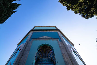 Low angle view of building against clear blue sky