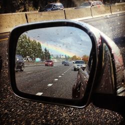 Reflection of car on side-view mirror