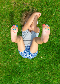 Low section of woman sitting on grass