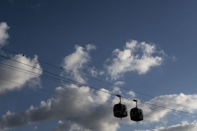 Low angle view of cable cars against sky