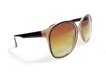 Close-up of sunglasses against white background